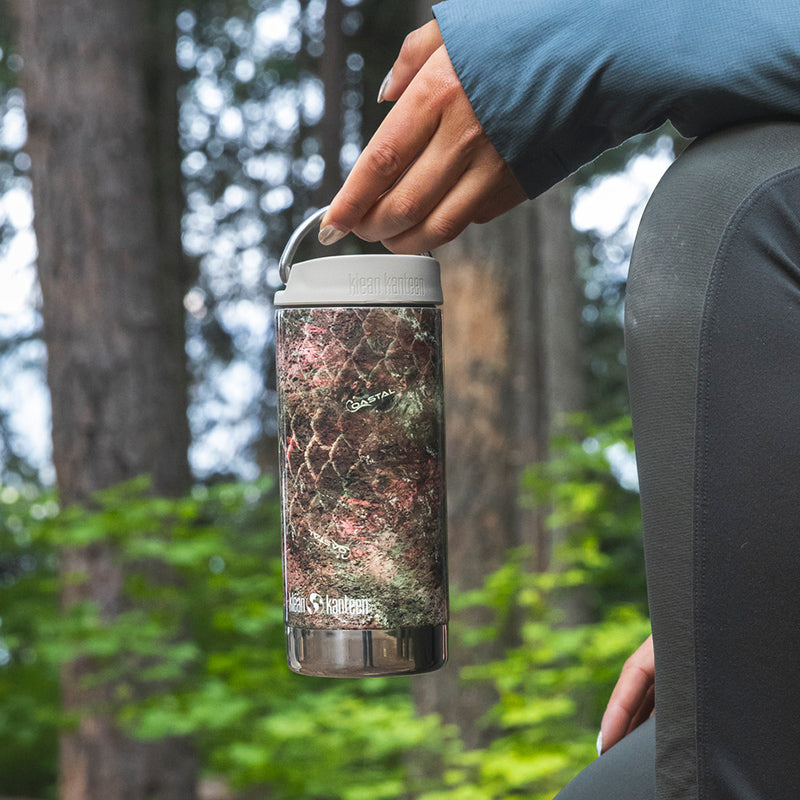 12oz-tkwide-with-twist-cap-mossy-oak-z9 12oz_tumbler_mossyoak_rainbowtrout_hand_closeup_square.jpg
