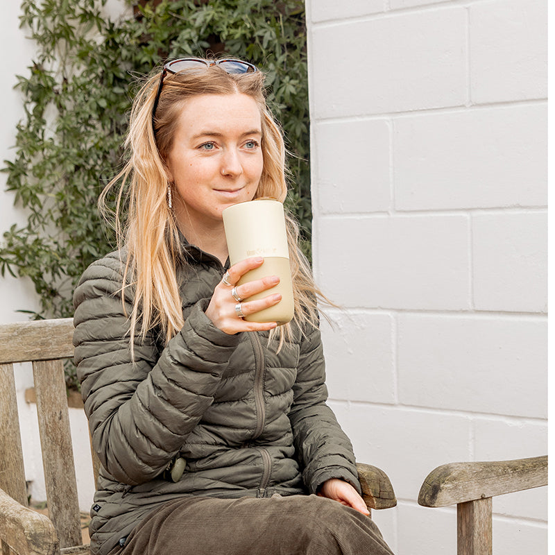 16oz-rise-tumbler-u7 16oz_rise_tumbler_wax_yellow_woman_seat_outside_square.jpg