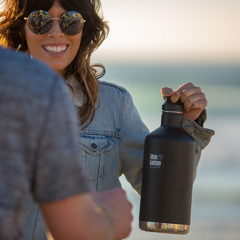64oz-classic-with-loop-cap-m4 64oz_insulated_classic_black_beach_girl_hand_square.jpg