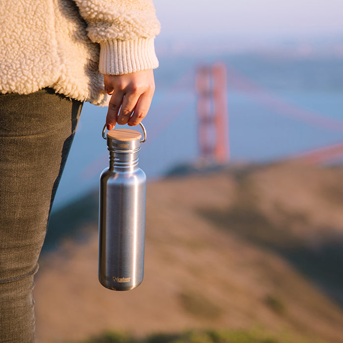 27oz-reflect-with-bamboo-cap-k4 K27SSLRF-BS-BAMBOO_reflect_bottle_bridge_lifestyle.jpg